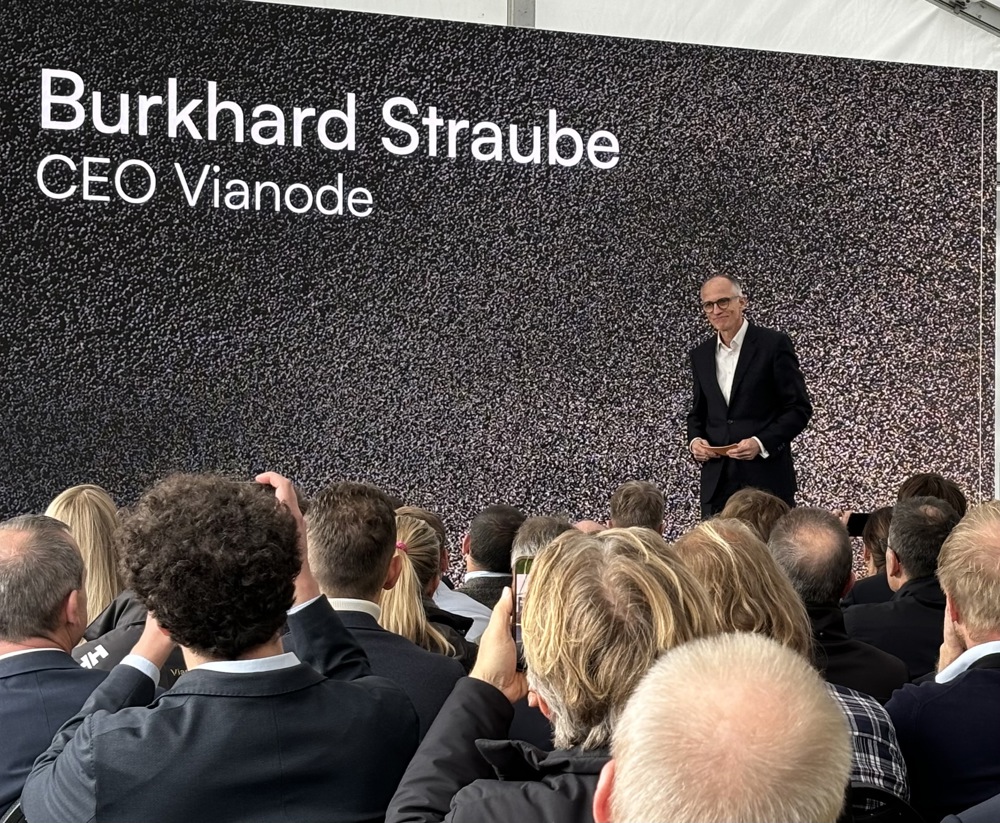 man in suit, on a podium