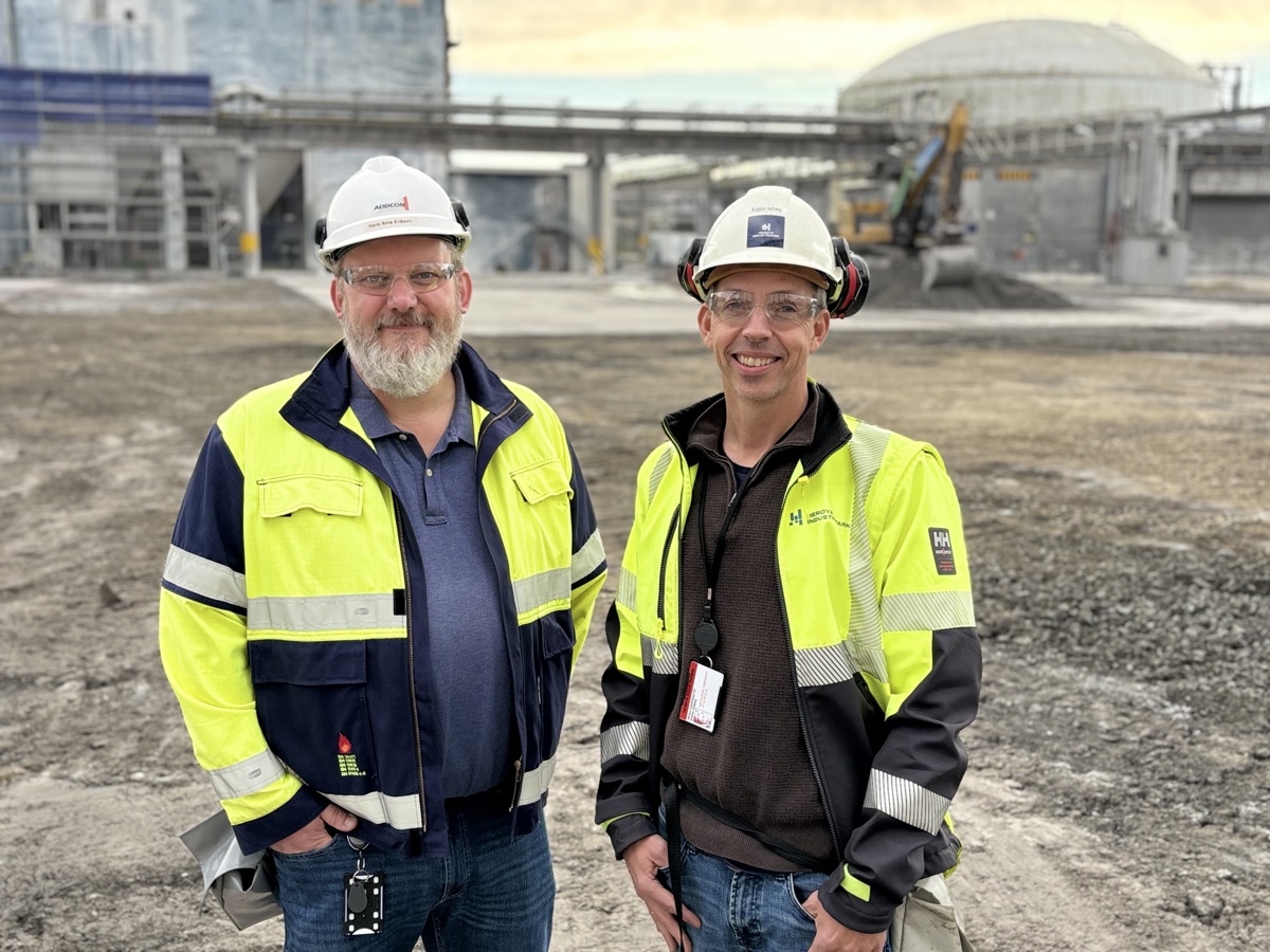 two men, yellow jackets, white helmets, industry, cleared plot