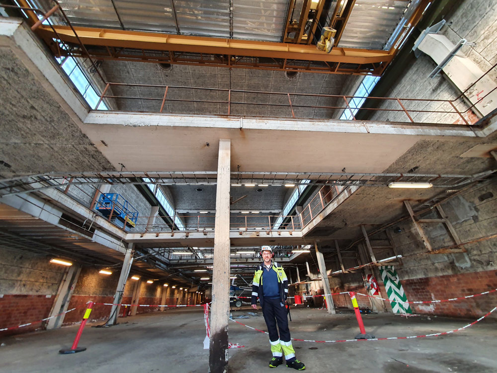 man standing in emply production hall, concrete