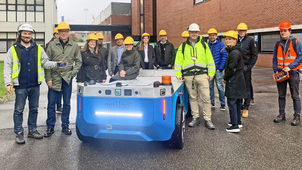 Visitors to the industrial park are given a demonstration of the pilot